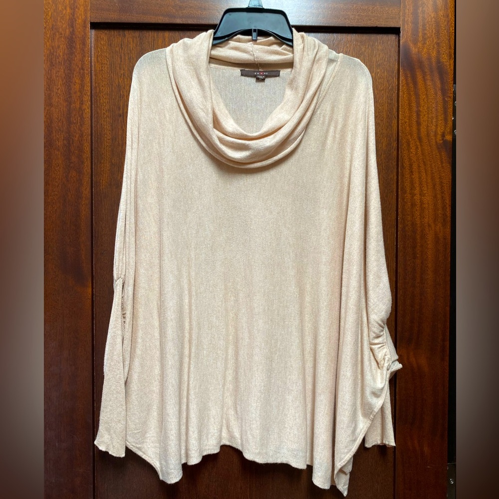Cowl-neck collar/off-shoulder bat-wing sweater in cream.
